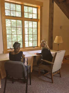 Carmen Oliver (right) working with an author at our Retreat Center.